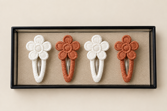 Embroidered flower snap clips pair.